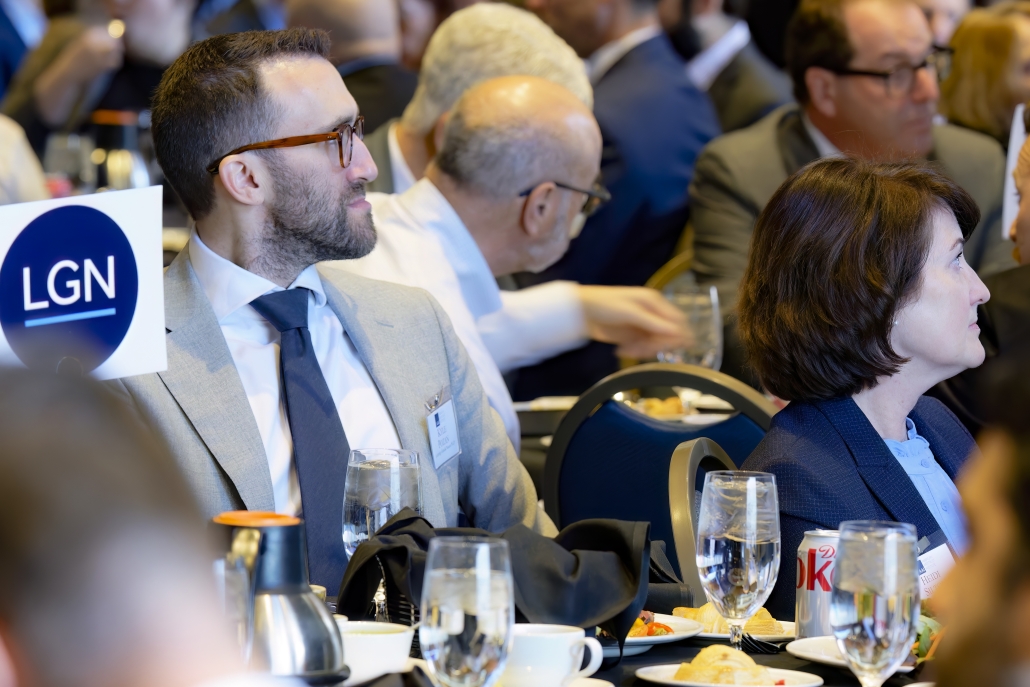 LGN colleagues seated and listening in support as Joseph Bruckner speaks.