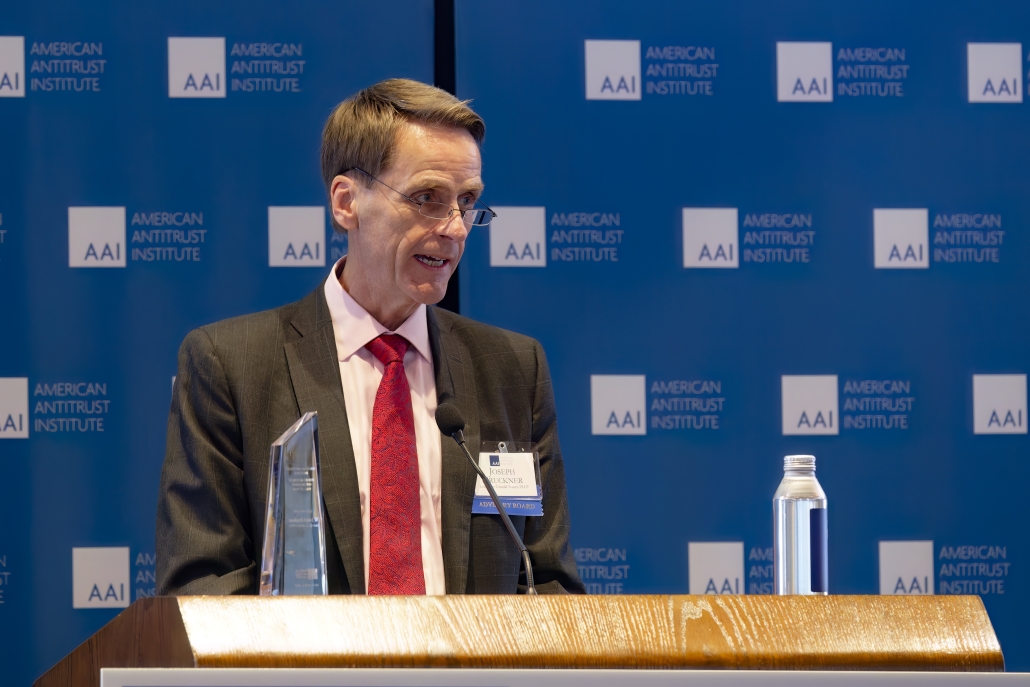 Joseph Bruckner speaking at the podium during his acceptance speech.